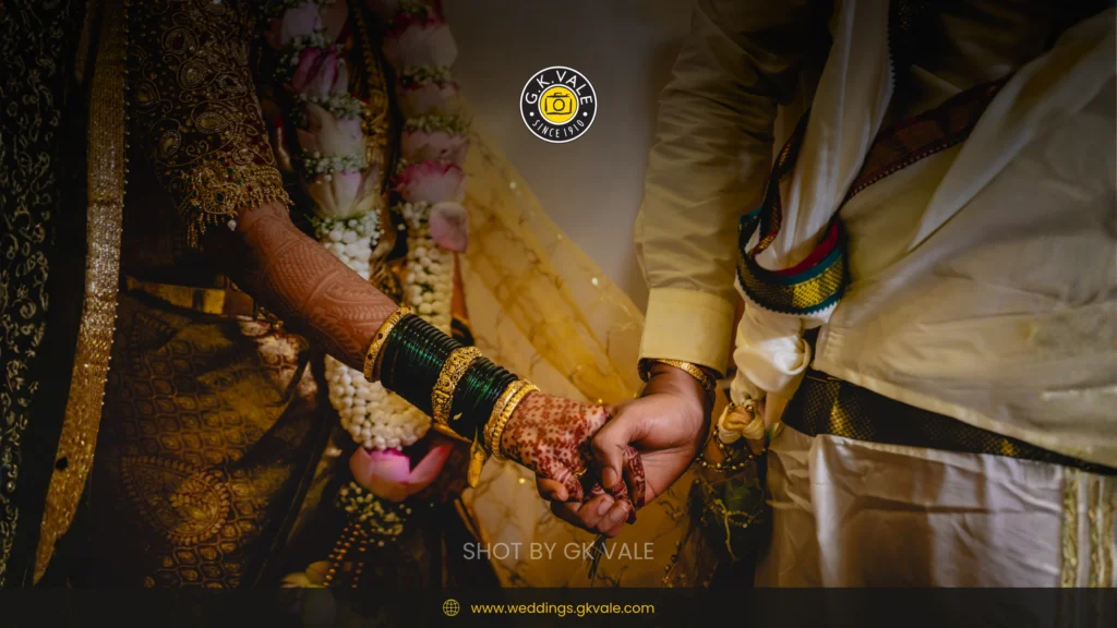 Candid wedding ritual moment showing the bride and groom holding hands during the ceremony