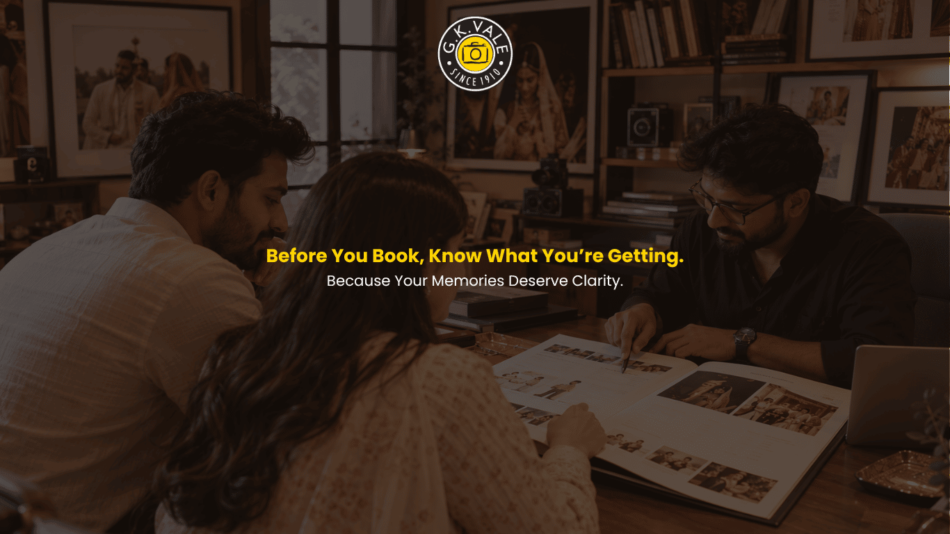 G.K. Vale wedding photography consultation with an engaged Indian couple reviewing a wedding photography package with a consultant in a heritage studio.